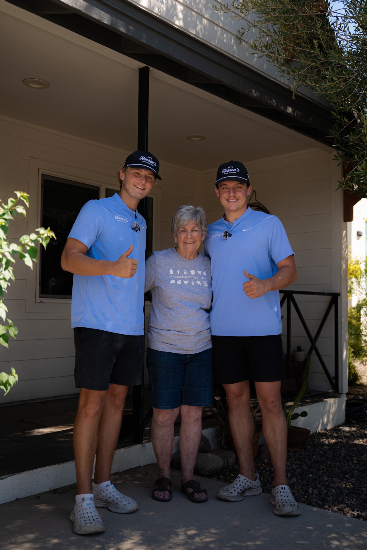Heeren's Home Services team with a happy customer outside her home